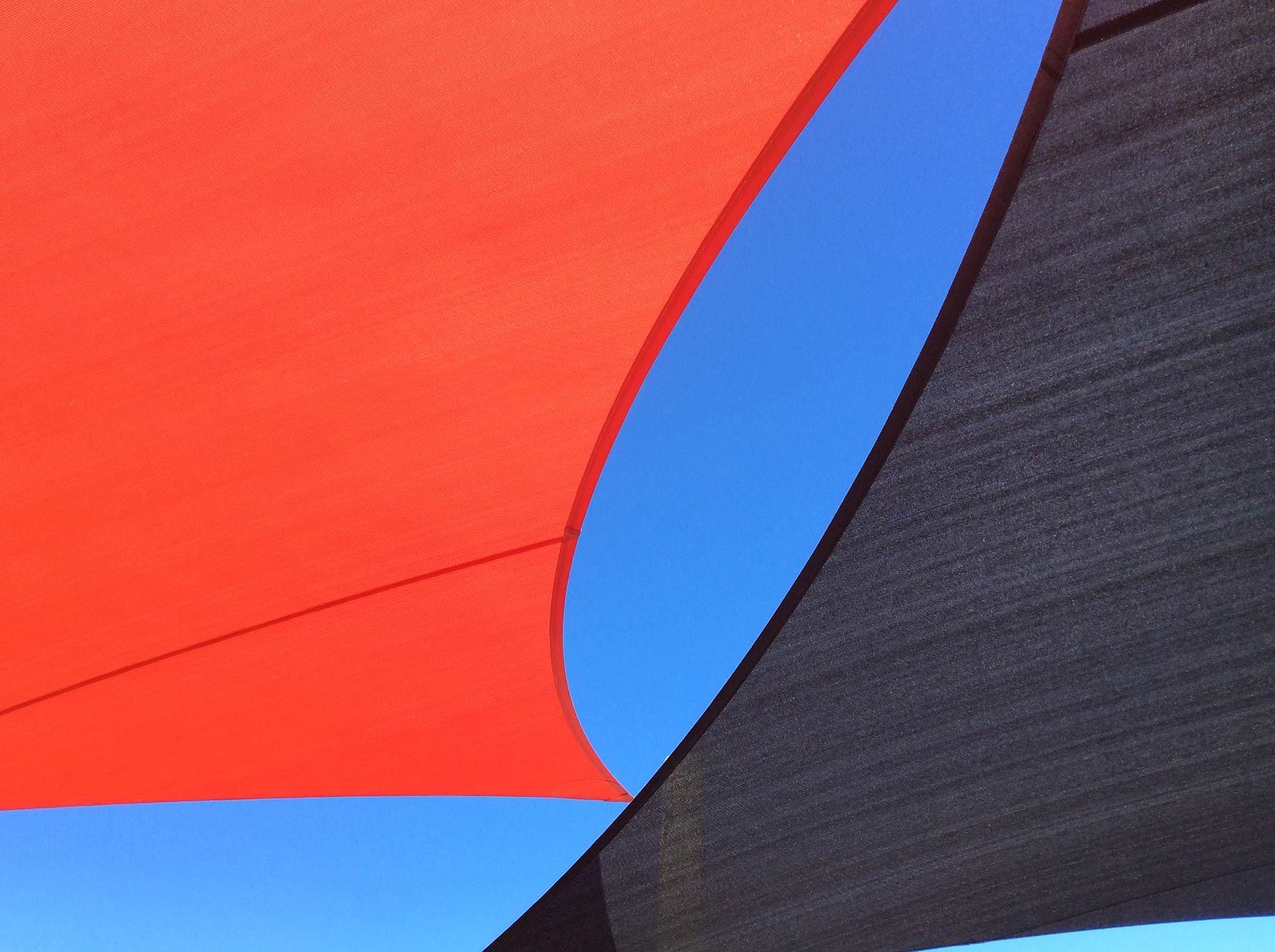 contrasting shade sails red and grey