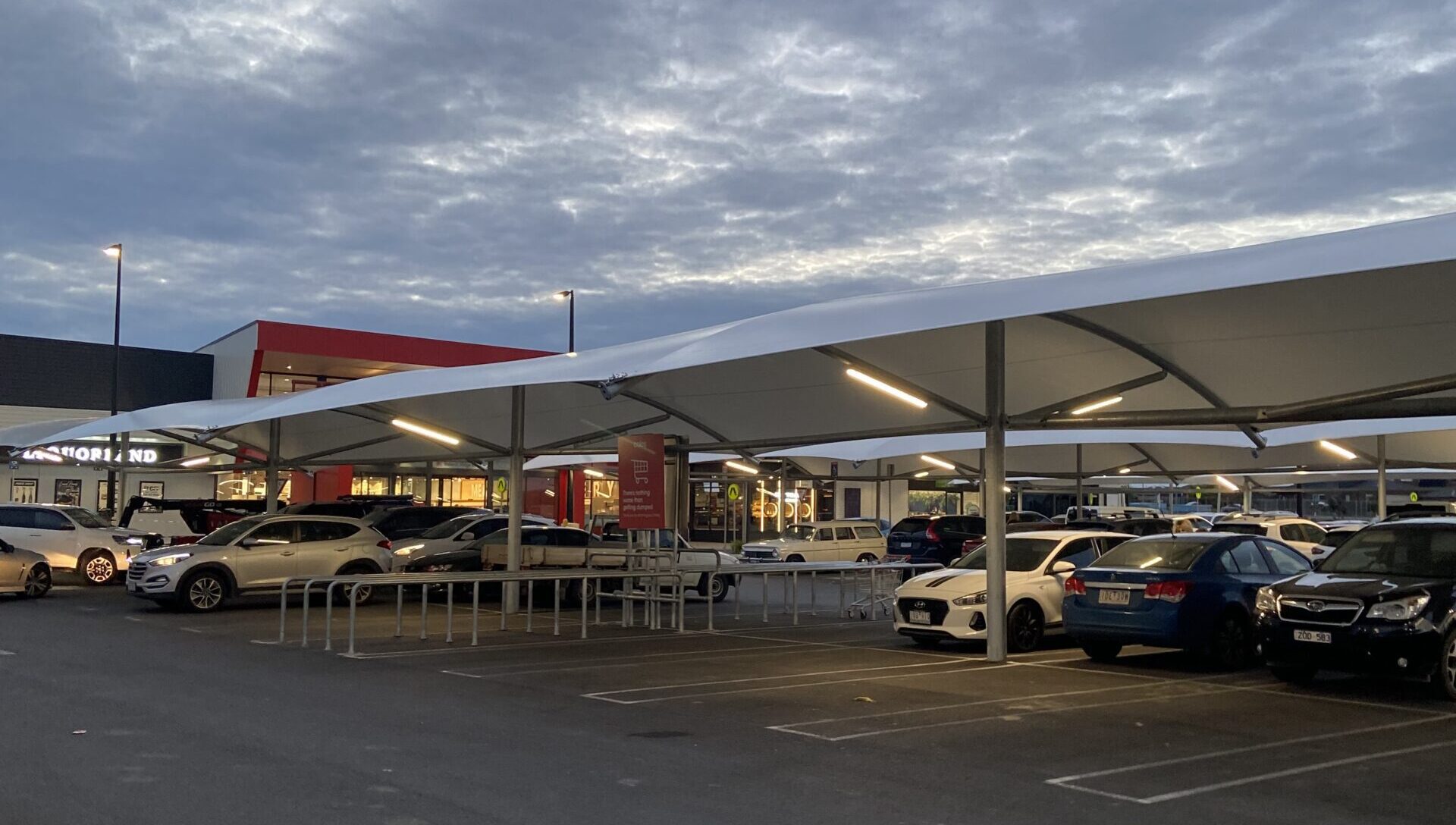 Car park shade structure Coles car park shade structure at dusk with lighting on
