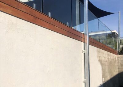 Large shade sail posts - Melbourne shade solutions. Post is bolted to a large wall and has a significant base plate at the bottom.